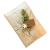 Eco-friendly natural Kraft paper gift wrapping with jute cord, handmade charms and recycled paper gift tag